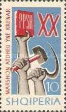 ‭Hands holding Communist manifest, hammer and sickle