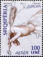 Hand holding quill pen and map of Europe