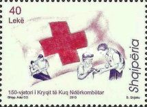 Red cross and aid workers helping injured man, feeding woman