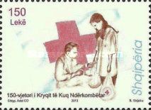 Red cross and worker giving bags of goods to man