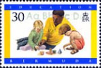 Man, children using blocks