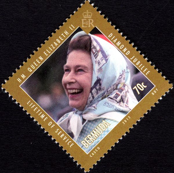 Queen (in a headscarf) laughing, at Windsor Polo Club in 198