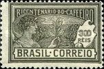 Woman holding a branch of coffee and coffee plantation