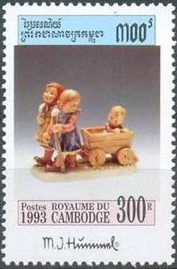 Girls pulling boy in cart