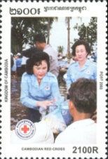 Queen and Prime Minister’s wife giving items to people