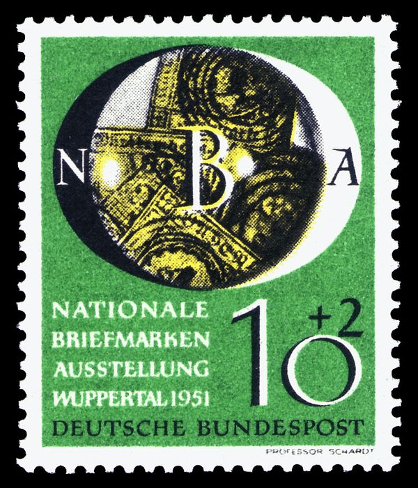Old German stamps under a magnifying glass