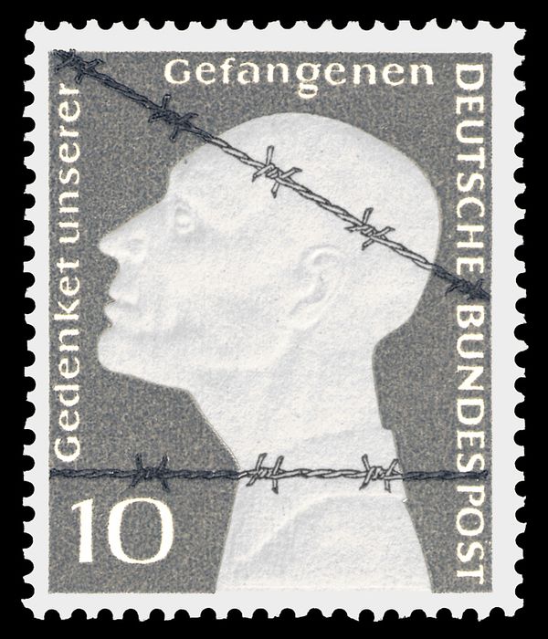 Prisoner behind barbed wire