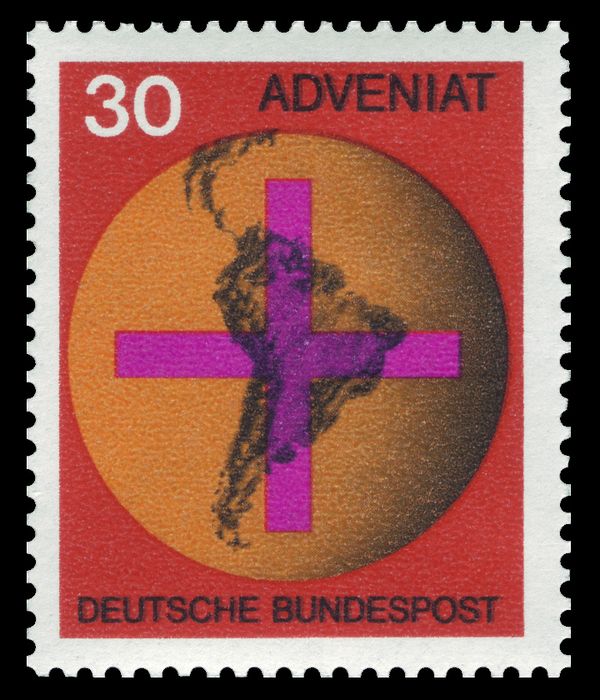 Cross in front of a globe with map of South America Adveniat