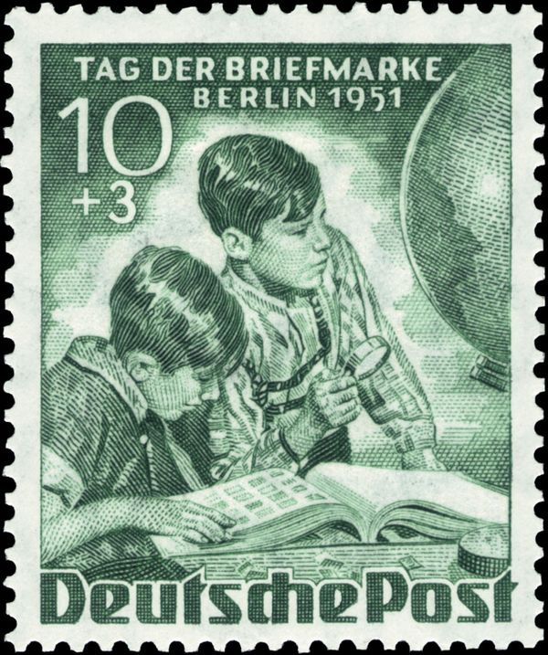 Boys with stamp album, globe
