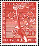 Torch, laurel wreath, Olympic rings