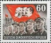 Workers, flag with heads of Marx, Engels, Lenin and Stalin