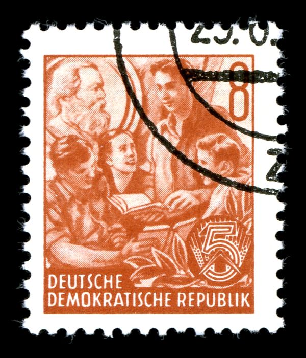 Students with picture of Karl Marx in the background