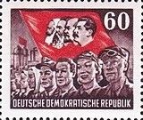 Workers, flag with heads of Marx, Engels, Lenin and Stalin