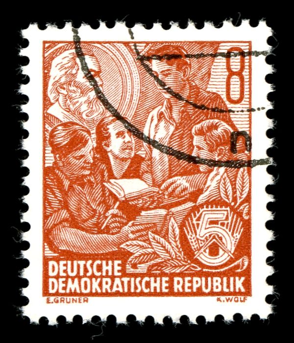 Students with picture of Karl Marx in the background