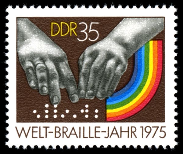 Hands Reading the Word Braille in Braille