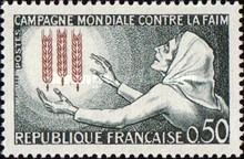 World Campaign against hunger. Woman and three ears of wheat
