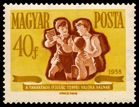 School boy showing his saving stamps