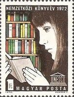 Reading girl in front of bookshelf, UNESCO emblem
