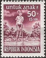Boy on bamboo stilts