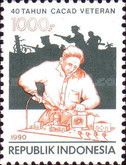 Battle and disabled man using soldering-iron