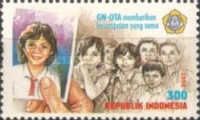 Hand with photo of a schoolgirl, children from poor families