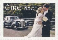 Bride, groom and wedding car
