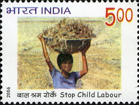 Boy in Fileds Carrying Heavy Basket