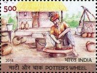 Man Using Potter's Wheel Outside Hut