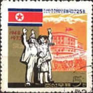 Flag, cheering family in front of party building
