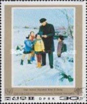 Kim Il looking at children’s school work