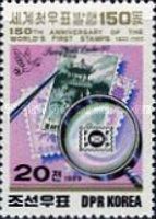 Stamps, tweezers and magnifying glass