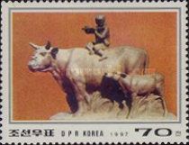 Cowboy playing flute, sitting on bul