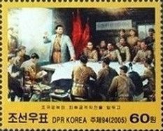 Kim Il Sung with maps at a military briefing