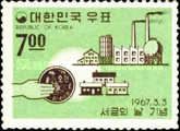 Hand holding coin, buildings