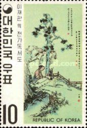 Man reading book under pine tree