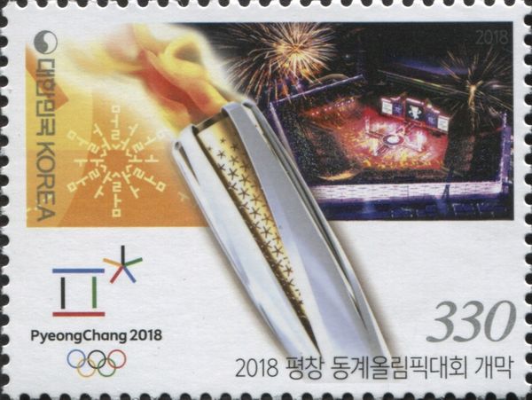Olympic torch, fireworks over stadium