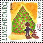 Child with Teddy Bear in front of the Christmas Tree