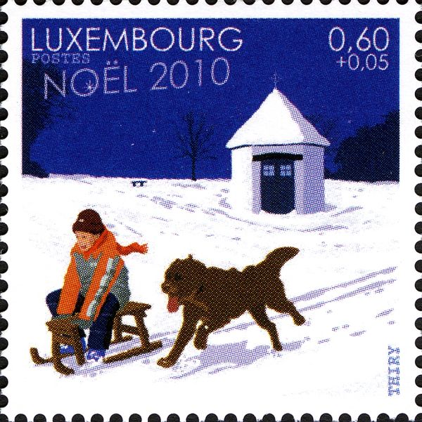 Child with Dog (Canis lupus familiaris) while sledding