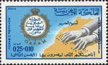 Hands of a Blind Person Reading Braille over Map of Morocco