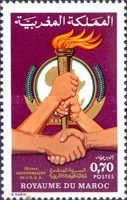 Handshake, Hands Holding Torch in front of the OAU Emblem