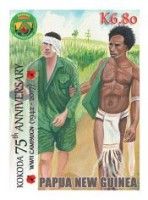 Wounded sodier being helped by a Papuan tribesman