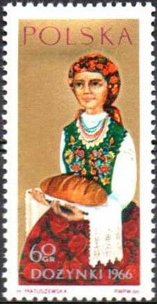 Woman Holding Loaf of Bread