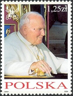 Wearing white vestments, seated