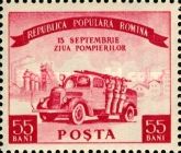 Fire engine with crew in front of an industrial plant