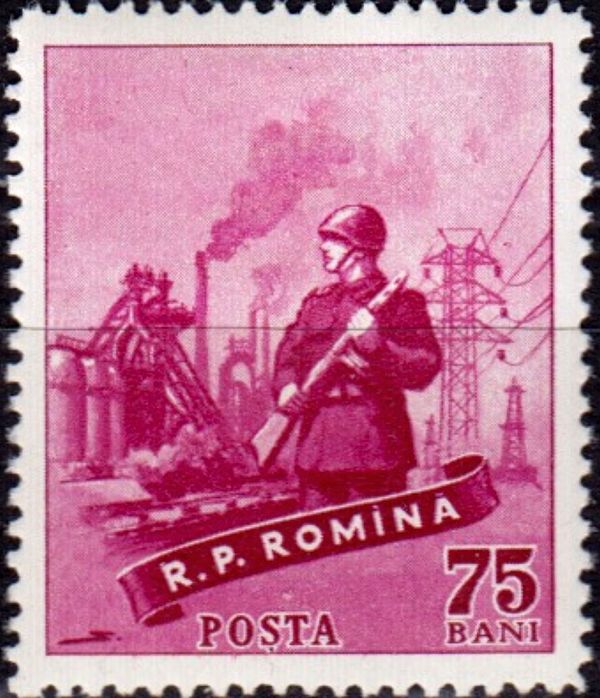 Soldier in front of industrial plant