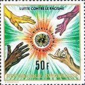 Hands of 4 races reaching for equality