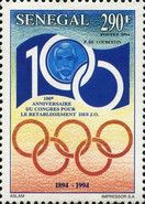 Coubertin within Anniversary Emblem and Olympic Rings
