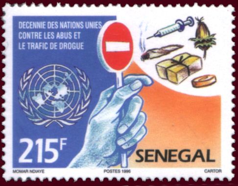 U.N. Emblem and Hand Holding up Stop Sign to Drugs