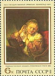 Young Woman Trying on Earrings, Rembrandt (1654)