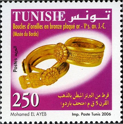 A Gold-plated Earring In Bronze